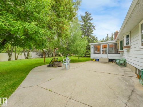 Expansive concrete patio with direct access to an enclosed sunroom - 11921 231 Street, Edmonton, AB 