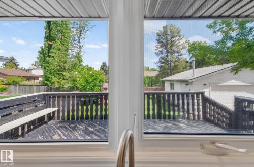 Outdoor deck featuring painted wood surface, built-in bench seating, and surrounding wood railing - 3 Galaxy Way, Sherwood Park, AB 