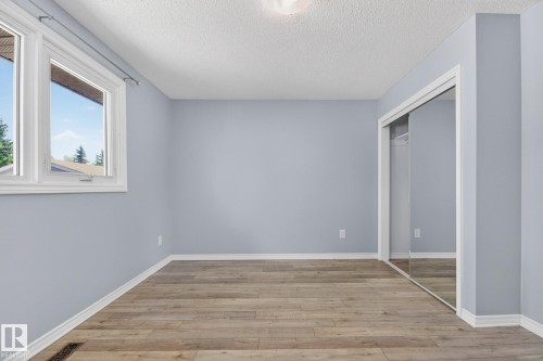 Room featuring wood-finish flooring, light blue walls, and white trim - 3 Galaxy Way, Sherwood Park, AB 