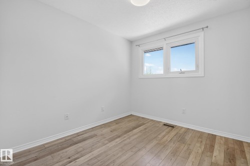 Room featuring light wood-finish flooring, white baseboards, and a neutral wall color - 3 Galaxy Way, Sherwood Park, AB 