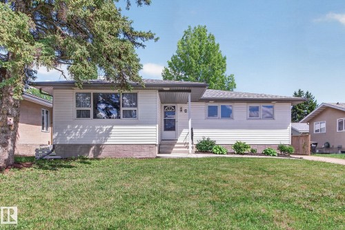 Single-story residence featuring white horizontal siding and a gray shingle roof - 3 Galaxy Way, Sherwood Park, AB 