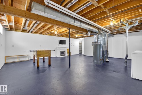 Unfinished basement space with painted concrete flooring and exposed ceiling beams - 3 Galaxy Way, Sherwood Park, AB 