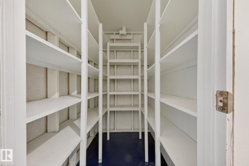 Ample storage room featuring multiple white shelving units and a dark blue floor - 3 Galaxy Way, Sherwood Park, AB 