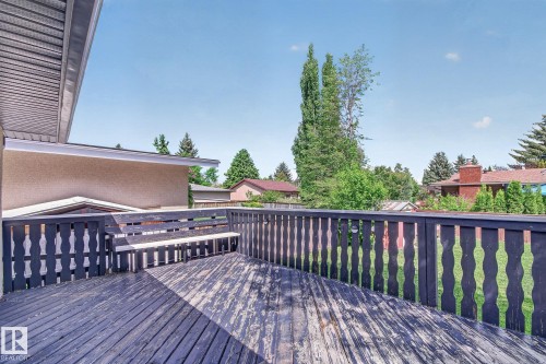 Outdoor wooden deck featuring a built-in bench and dark wood railing - 3 Galaxy Way, Sherwood Park, AB 