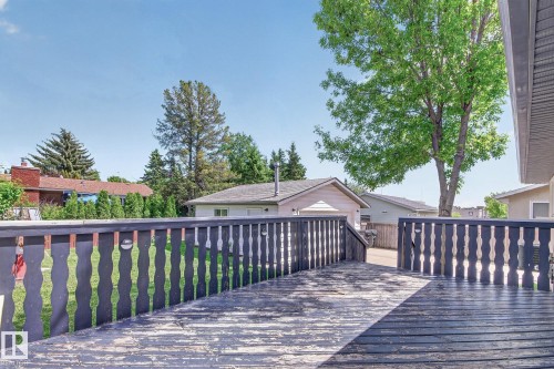 Exterior deck with dark-stained wood flooring and matching balusters - 3 Galaxy Way, Sherwood Park, AB 