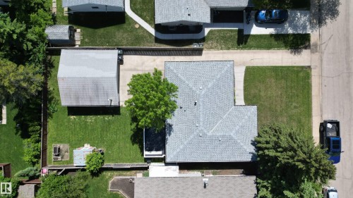 Expansive property featuring a large main residence with a gray shingle roof, a detached garage structure, and a secondary shed - 3 Galaxy Way, Sherwood Park, AB 