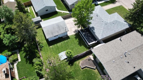 Expansive green lawn with mature trees and a detached garage - 3 Galaxy Way, Sherwood Park, AB 