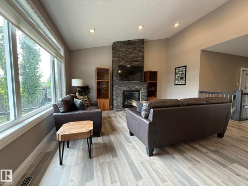 Spacious living area featuring a vaulted ceiling and light wood-finish flooring - 2 104 Allard Link, Edmonton, AB 