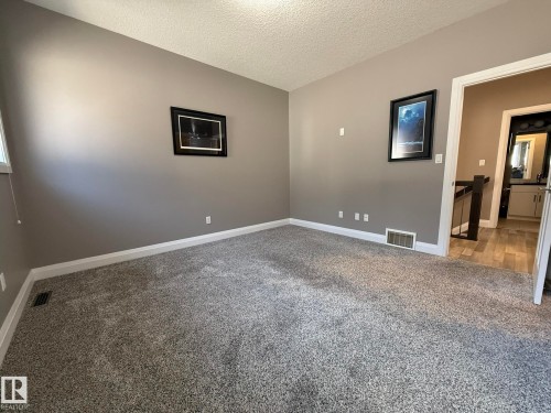 Carpeted room with neutral tone walls - 2 104 Allard Link, Edmonton, AB 