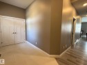 Entryway featuring light-toned tile flooring, white baseboards, and a neutral wall color - 2 104 Allard Link, Edmonton, AB 