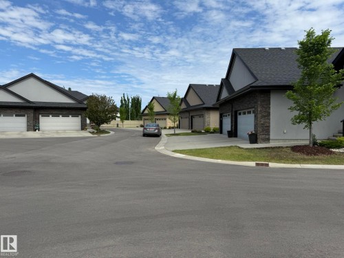 Paved cul-de-sac featuring multiple residences with distinct architectural styles - 2 104 Allard Link, Edmonton, AB 