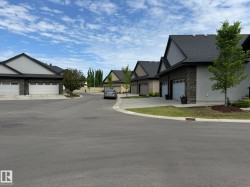 Paved cul-de-sac featuring multiple residences with distinct architectural styles - 