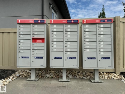 Community mailbox cluster with three units, each featuring individual compartments - 2 104 Allard Link, Edmonton, AB 