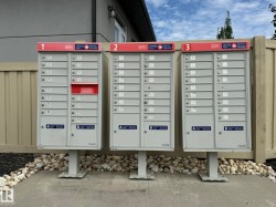 Community mailbox cluster with three units, each featuring individual compartments - 
