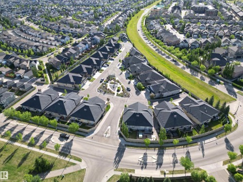 Residential community featuring a variety of single-family homes with dark-pitched roofs and light-colored siding - 2 104 Allard Link, Edmonton, AB 