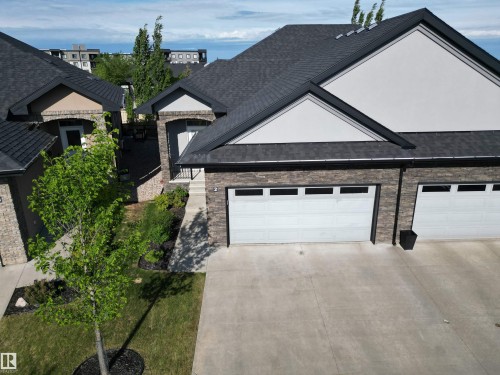 Contemporary residence featuring stacked stone and stucco exterior - 2 104 Allard Link, Edmonton, AB 
