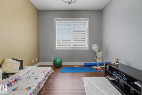 Room featuring wood-finish flooring and a neutral color palette - 3036 59 Avenue, Rural Leduc County, AB 
