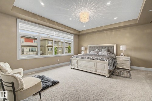 Spacious room featuring broadloom carpeting and a tray ceiling - 3036 59 Avenue, Rural Leduc County, AB 