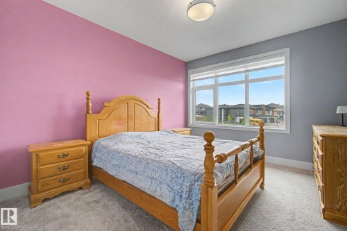 Bedroom featuring light gray carpet flooring and a large multi-pane window - 3036 59 Avenue, Rural Leduc County, AB 
