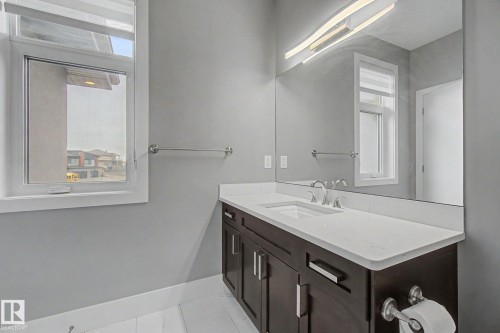 Contemporary bathroom vanity with a white countertop and undermount sink - 3036 59 Avenue, Rural Leduc County, AB 