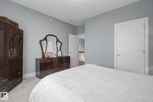 Grey wall paint with white trim, light grey carpet flooring, and a modern interior door with horizontal paneling - 3036 59 Avenue, Rural Leduc County, AB 