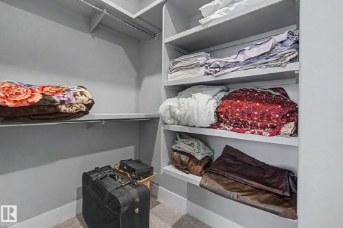 Built-in closet system featuring multiple shelving units and hanging rods - 3036 59 Avenue, Rural Leduc County, AB 