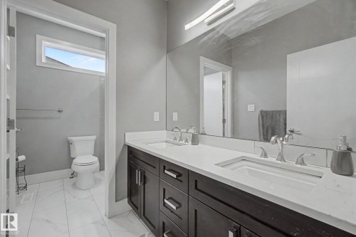 Double vanity with white countertops, undermount sinks, and chrome faucets - 3036 59 Avenue, Rural Leduc County, AB 