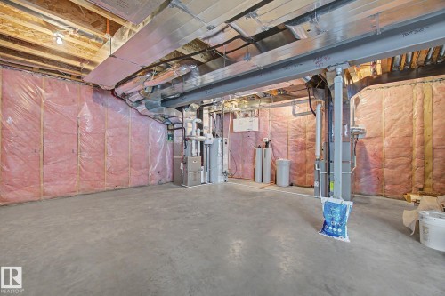 Unfinished basement with concrete flooring and exposed ceiling joists - 3036 59 Avenue, Rural Leduc County, AB 