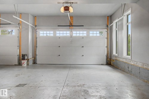 Two-car garage featuring automatic openers and durable concrete flooring - 3036 59 Avenue, Rural Leduc County, AB 