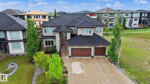 Two-story residence featuring a dark shingle roof and a stucco and stone facade - 3036 59 Avenue, Rural Leduc County, AB 