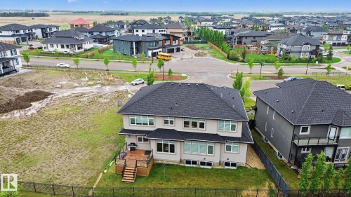 Rear exterior featuring a multi-level composite deck with black railing and steps to the fenced yard - 3036 59 Avenue, Rural Leduc County, AB 