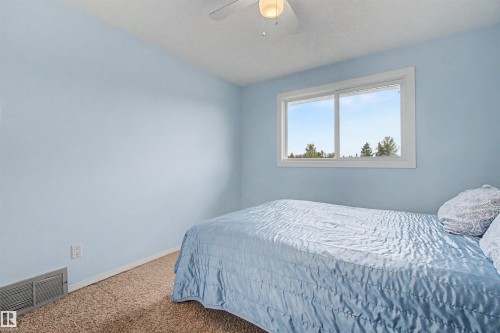 Room featuring a single window, a ceiling fan with integrated lighting, wall-to-wall carpeting, and light blue wall finishes - 2068 45 Street, Edmonton, AB - Indoor Photo Showing Bedroom