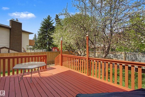 Spacious wooden deck featuring a warm-toned finish, full railings, and a wide area for outdoor furnishing - 2068 45 Street, Edmonton, AB - Outdoor With Deck Patio Veranda
