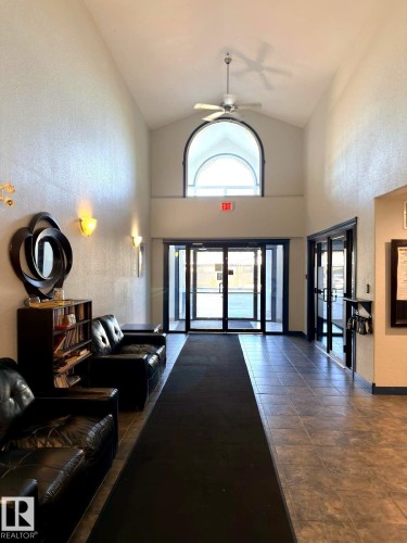 Vaulted entry with an arched window and ceiling fan - 312 2305 35A Avenue, Edmonton, AB 