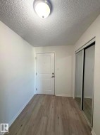 Entryway featuring light wood-finish flooring and a white paneled door - 