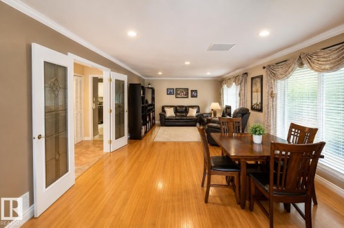 Open-concept living area featuring wood-finish flooring, recessed lighting, white crown molding, and large windows with blinds - 58124 Secondary 881, Rural St. Paul County, AB - Indoor Photo Showing Dining Room