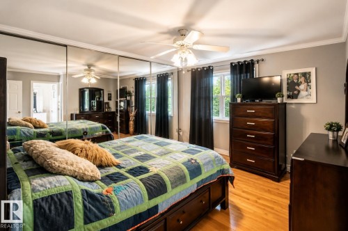 Bedroom with wood-finish flooring, a ceiling fan, and a window providing natural light - 58124 Secondary 881, Rural St. Paul County, AB - Indoor Photo Showing Bedroom
