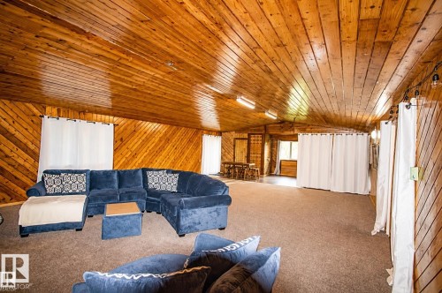 Spacious room with wood-paneled walls and ceiling - 58124 Secondary 881, Rural St. Paul County, AB - Indoor