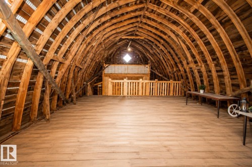 Vaulted wood-beam ceiling with exposed structural elements - 58124 Secondary 881, Rural St. Paul County, AB - Indoor Photo Showing Other Room