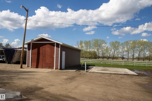 Detached shed with gabled roof, brown siding, and large double doors - 58124 Secondary 881, Rural St. Paul County, AB - Outdoor