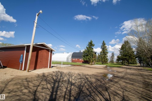 Red-sided outbuilding with white trim and a gabled roof - 58124 Secondary 881, Rural St. Paul County, AB - Outdoor