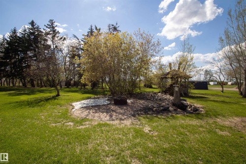 Expansive outdoor space featuring a circular paver patio, a small gazebo structure, and a rock garden - 58124 Secondary 881, Rural St. Paul County, AB - Outdoor With View