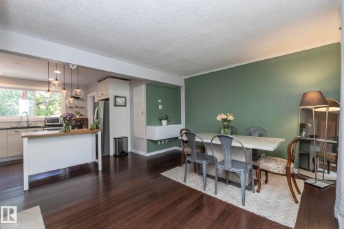 Kitchen and dining area featuring dark wood-finish flooring - 7719 86 Avenue, Edmonton, AB 