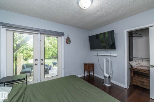 Dark wood-finish flooring with light gray walls and a textured white ceiling - 7719 86 Avenue, Edmonton, AB 