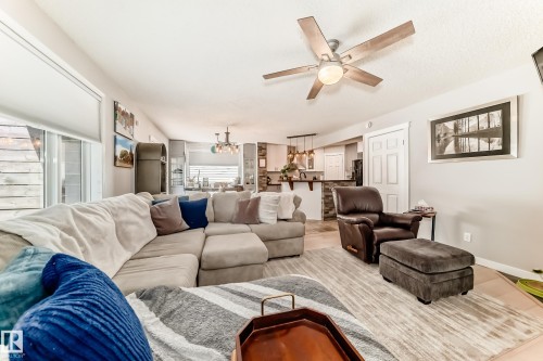 Living area featuring wood-finish flooring and a ceiling fan with light fixture - 13 Orchid Place, St. Albert, AB 