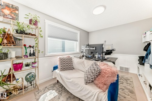 Room featuring a window with cellular blinds, light-colored walls, and wood-finish flooring - 13 Orchid Place, St. Albert, AB 