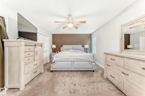 Carpeted room featuring a ceiling fan, a window with blinds, and white painted walls with a contrasting accent wall - 13 Orchid Place, St. Albert, AB 