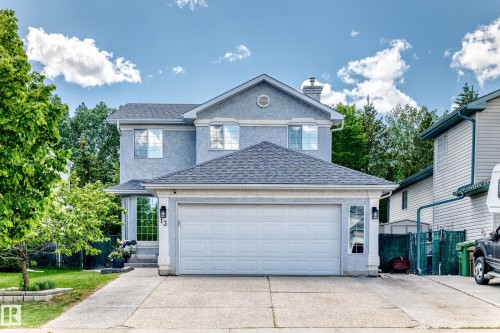 Two-story stucco residence featuring an attached double-car garage - 13 Orchid Place, St. Albert, AB 