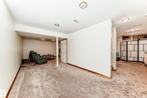 Finished lower level featuring recessed lighting, a white painted column, and neutral carpet flooring - 13 Orchid Place, St. Albert, AB 