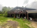 Split-level residence featuring a prominent upper deck with wood railing - 27 52330 Rge Road 15, Rural Parkland County, AB 